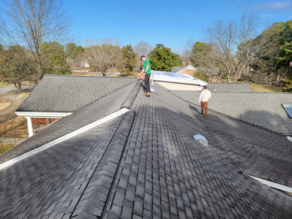 best roofing companies in wake forest nc two men on top of shingles roof